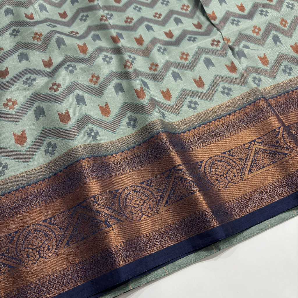 Sage green saree fabric and ornamental border detail