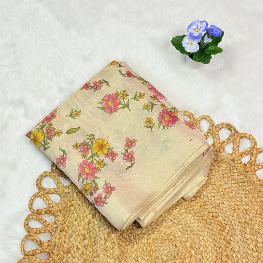 Floral fabric on a textured surface with a small plant in the corner