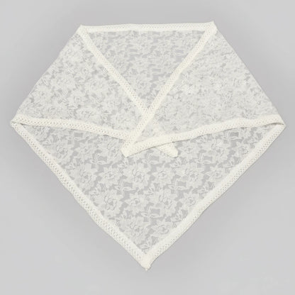 White lace doily on a gray background