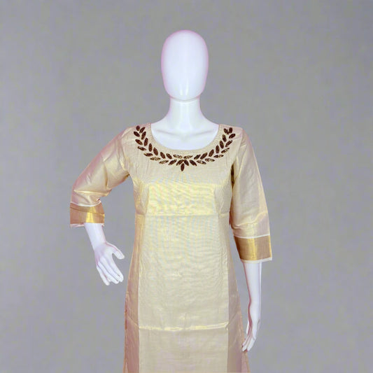 Mannequin wearing a cream-colored dress with gold accents on a gray background