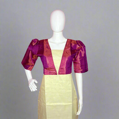 Mannequin wearing a purple and pink patterned top over a yellow dress on a pink background