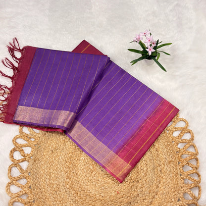 Wine Bapta Tussar saree with woven gold zari lines, subtle sequin accents, tasselled pallu, and matching blouse piece, folded on a natural jute mat