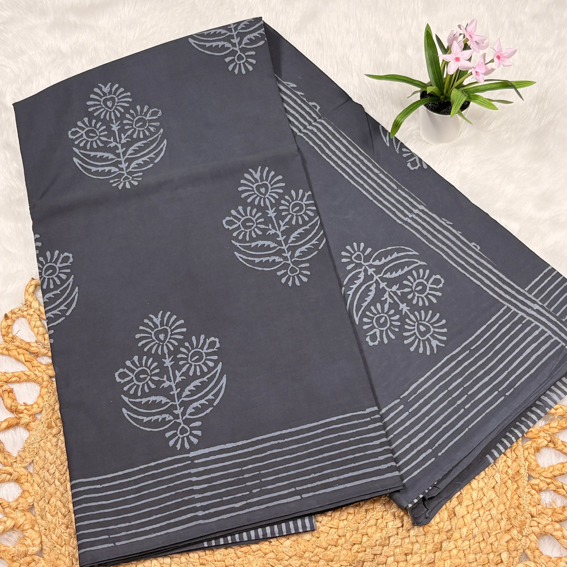 Gray fabric with white floral patterns on a textured surface