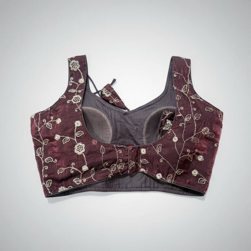 Bra and panties set with floral embroidery on a textured surface