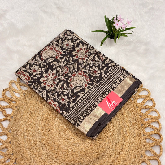 Maheshwari Bagru block print saree in deep brown with ivory floral vines, gold zari border, tasselled pallu, and matching blouse piece”