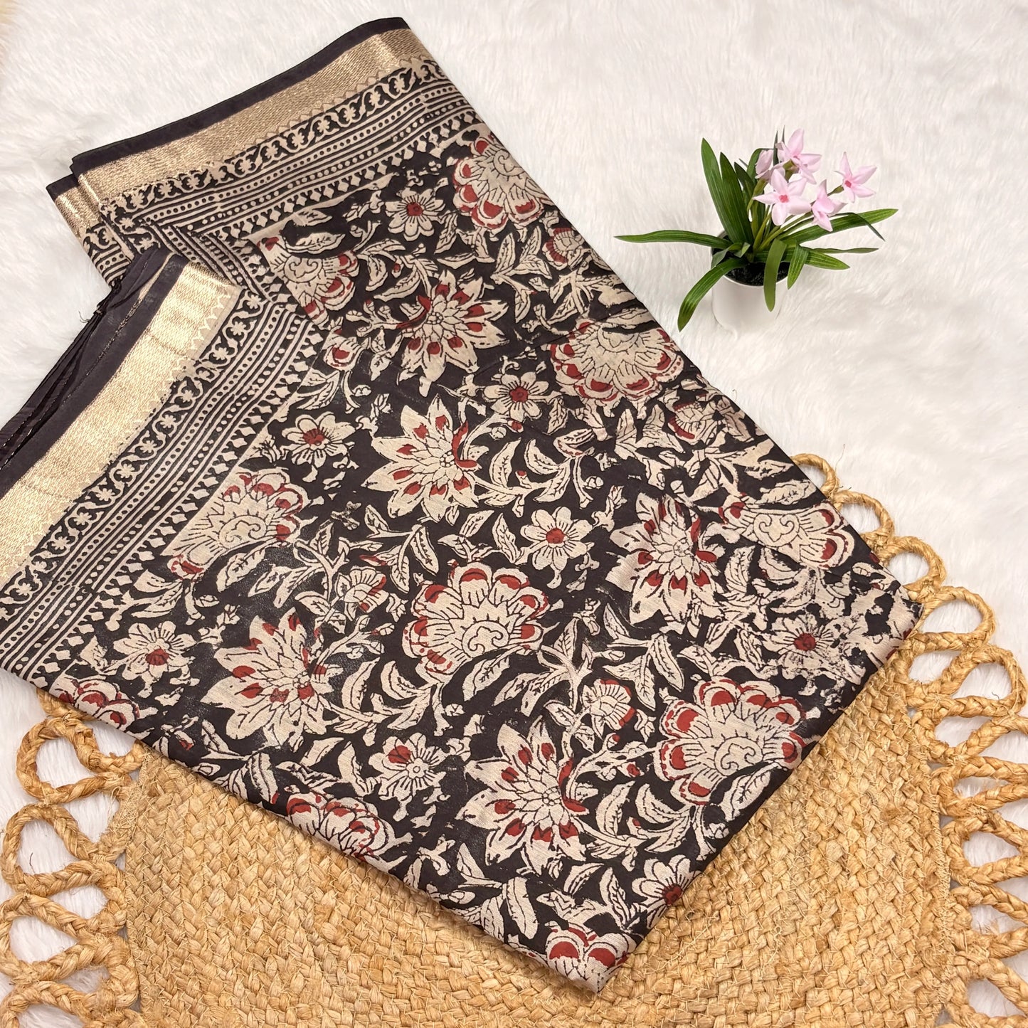Maheshwari Bagru block print saree in deep brown with ivory floral vines, gold zari border, tasselled pallu, and matching blouse piece”