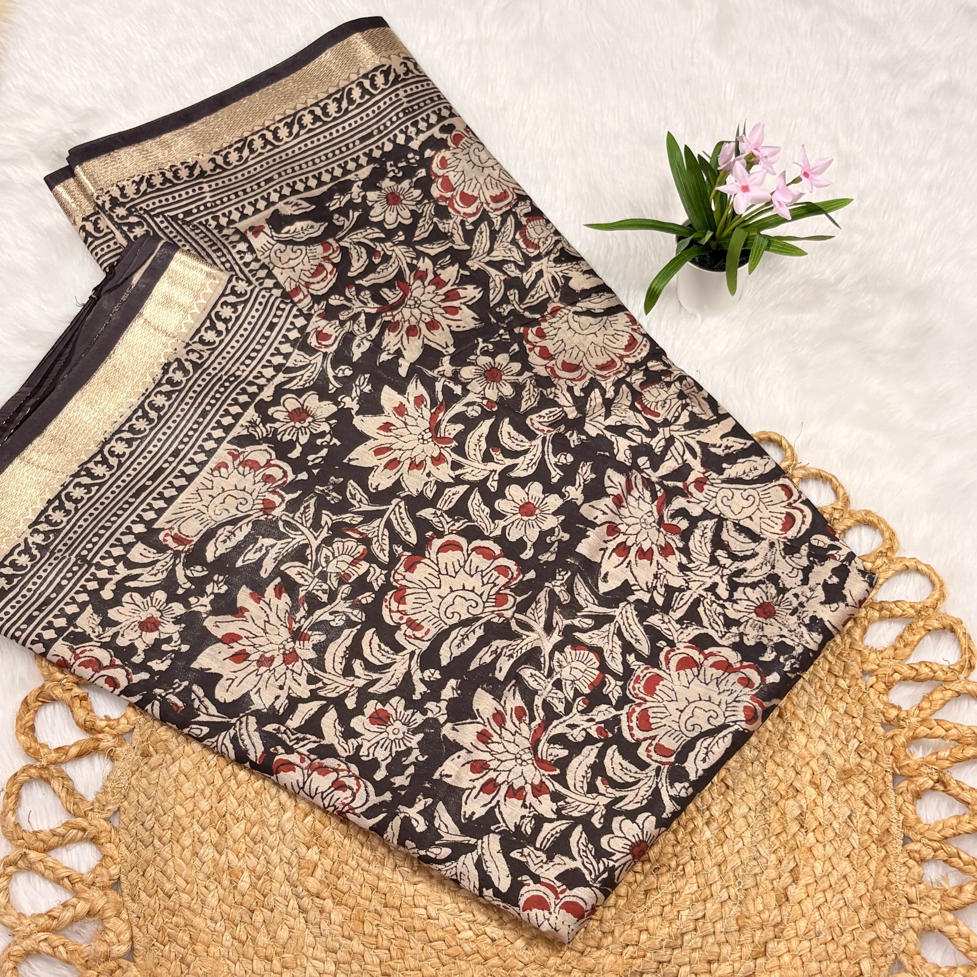 Maheshwari Bagru block print saree in deep brown with ivory floral vines, gold zari border, tasselled pallu, and matching blouse piece”
