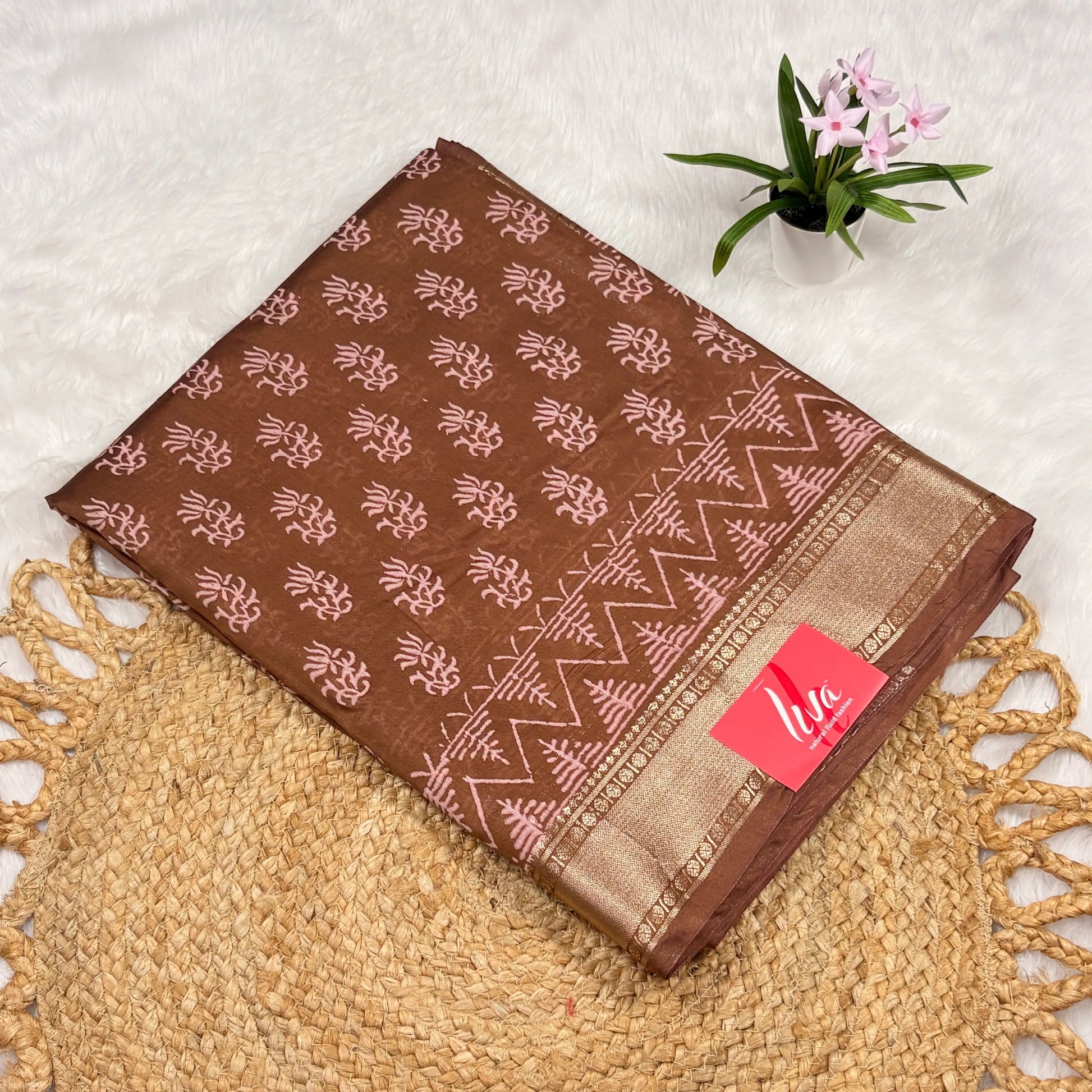 Cocoa‑brown Maheshwari art silk saree with blush block motifs, zigzag border, soft gold zari band, and matching blouse piece