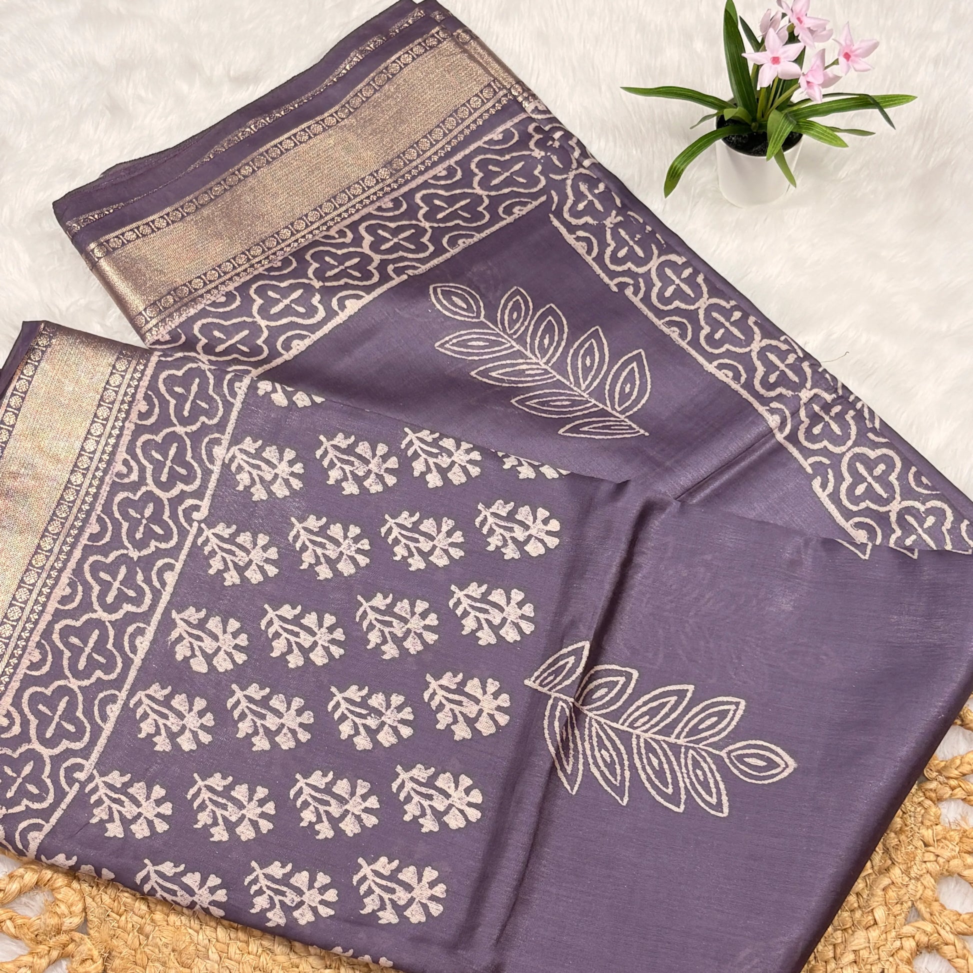 Purple fabric with white floral patterns on a textured surface