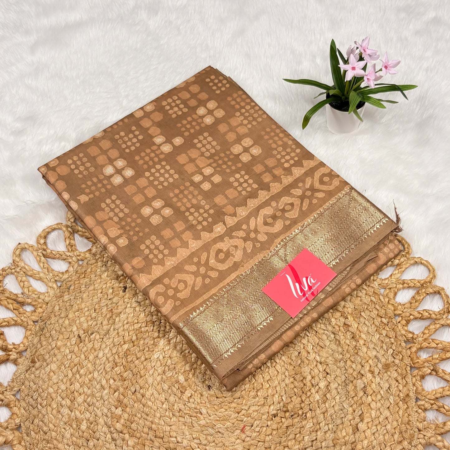 Tan Maheshwari Dabu block print saree with dotted check motifs, geometric borders, soft gold zari band, and matching blouse piece