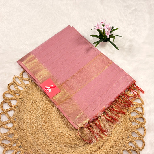 Blush‑pink Mangalgiri saree with fine gold jari checks, gold pallu, tasselled edge, and matching blouse piece, folded on a natural mat