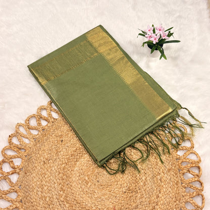 Olive green Mangalgiri saree with fine gold jari checks, tasselled pallu, and matching blouse piece, folded on a natural mat