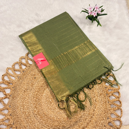 Olive green Mangalgiri saree with fine gold jari checks, tasselled pallu, and matching blouse piece, folded on a natural mat