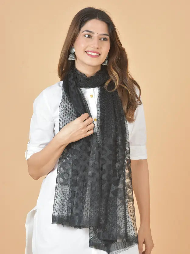 Woman wearing a black scarf with a beige background