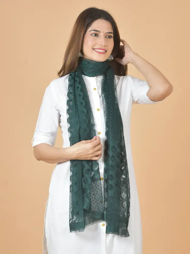 Woman wearing a green scarf against a beige background