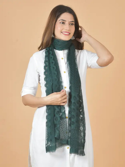 Woman wearing a green scarf against a beige background