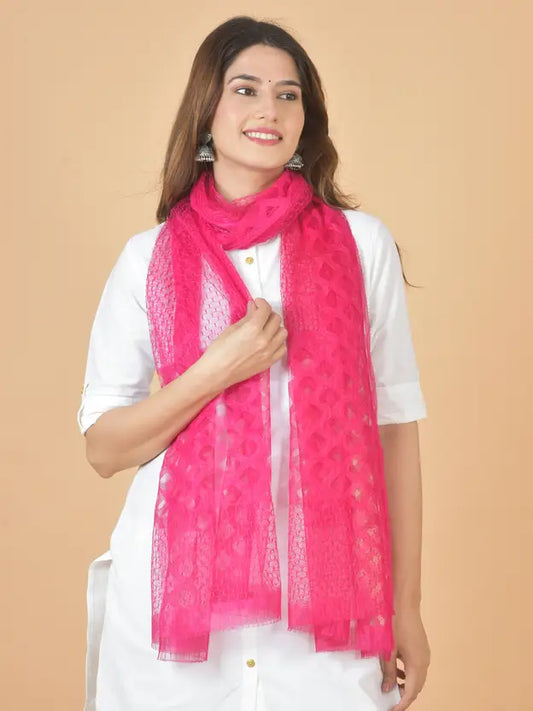 Woman wearing a bright pink scarf on a beige background