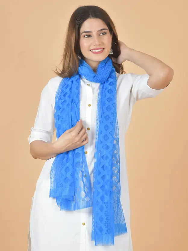 Woman wearing a blue scarf against a beige background