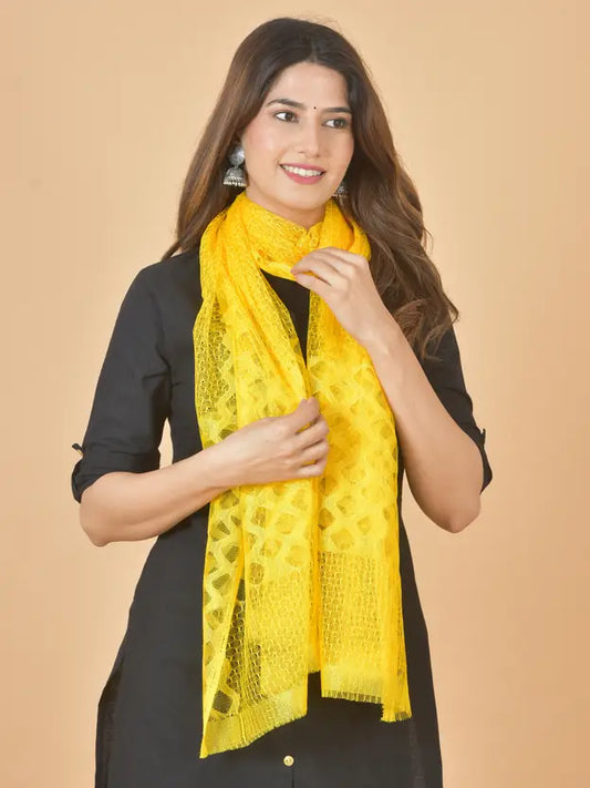 Woman wearing a yellow scarf against a beige background