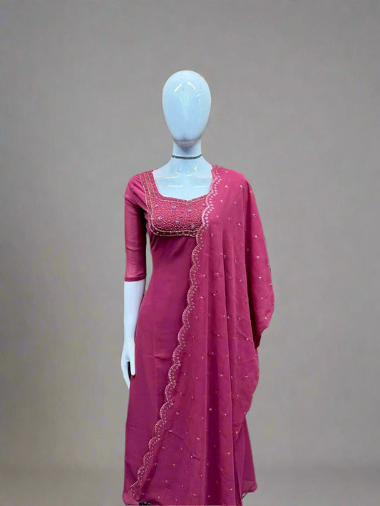 Mannequin wearing a pink traditional outfit with a geometric patterned wall background