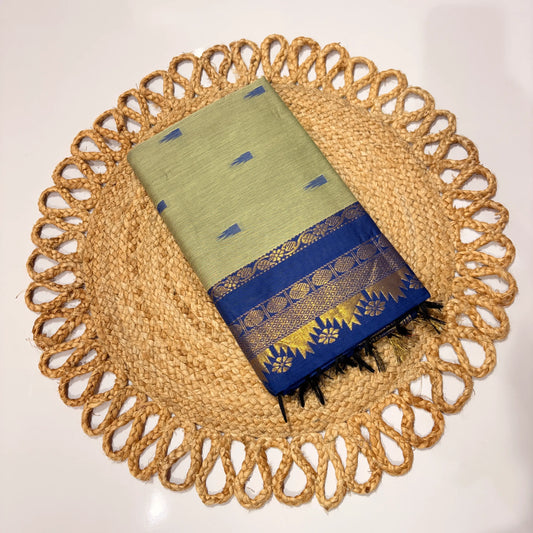 Green and blue fabric with gold patterns on a woven placemat