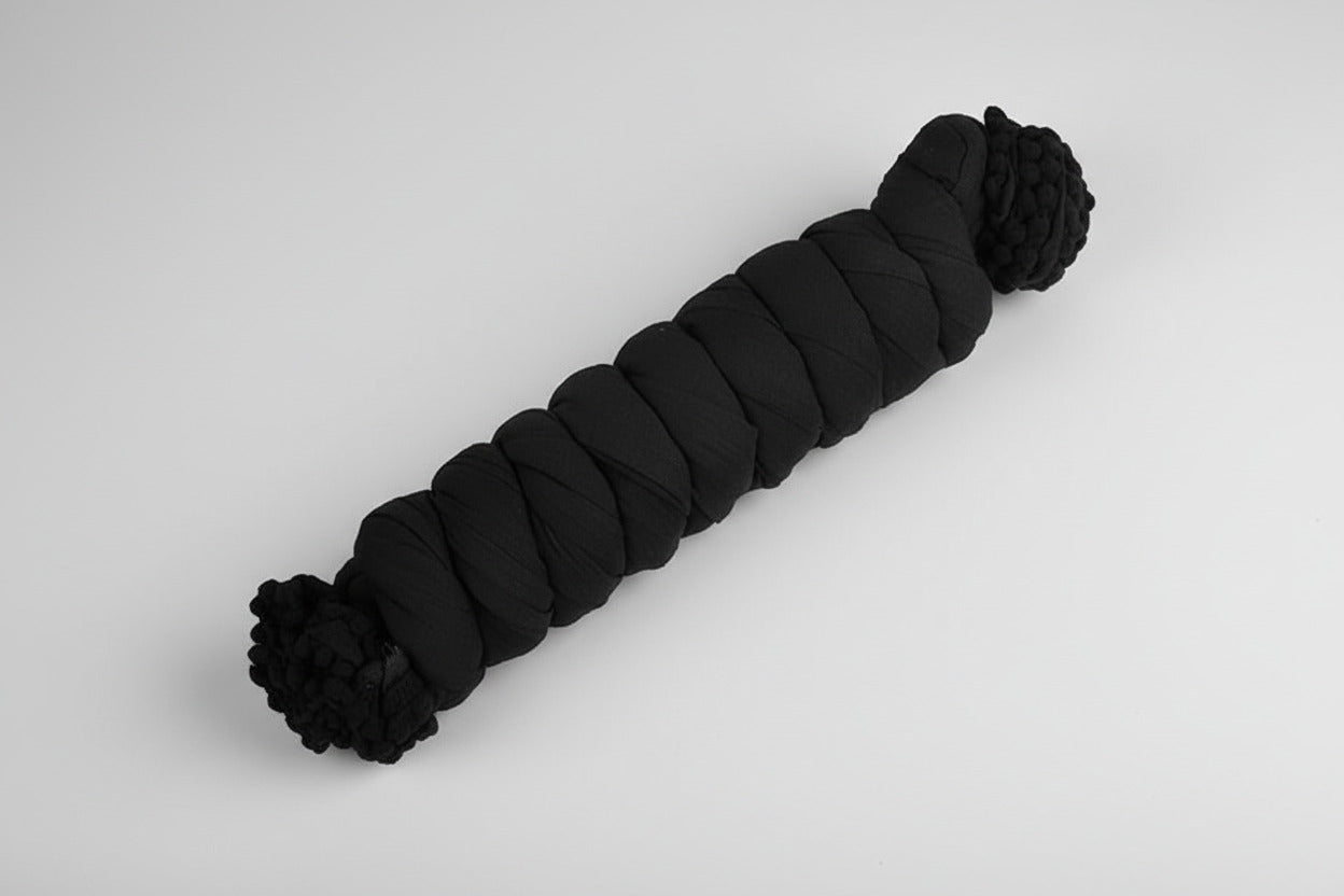 Black skein of yarn on a white background