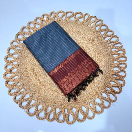 Blue and brown patterned fabric on a woven mat with a blue background