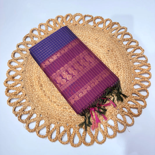 Purple woven fabric with gold patterns on a round woven placemat