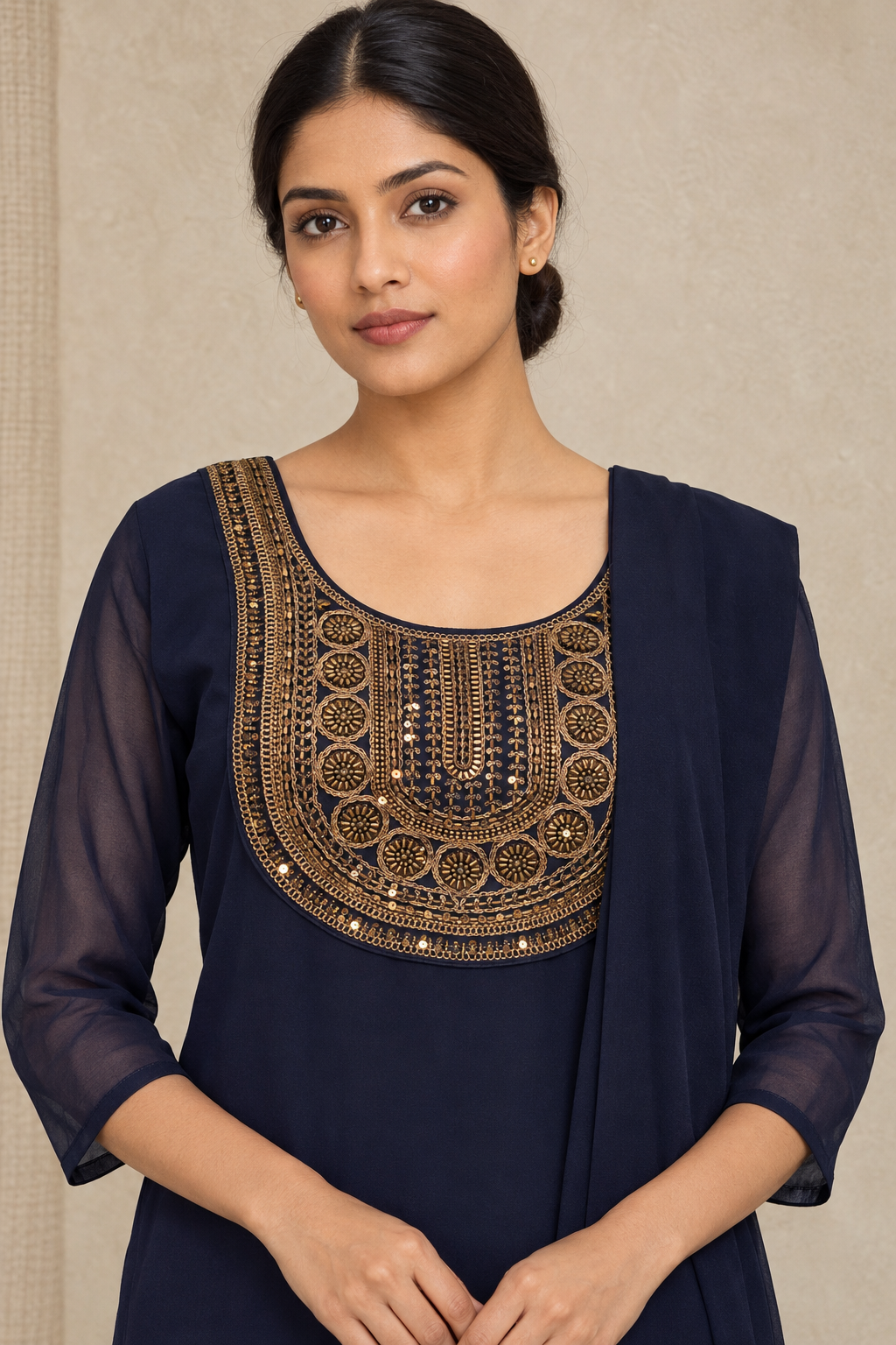 Close-up of the navy kurta's gold-toned decorated yoke