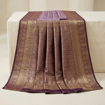 Dark plum and gold-tone saree pallu display