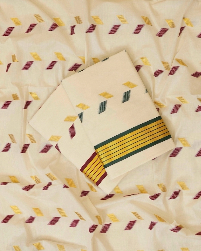 Off-white Kerala cotton saree with scattered multicolour woven diamond butta motifs in maroon, yellow, teal and olive, multicolour stripe border in yellow, green and maroon – flat lay showing full fabric spread