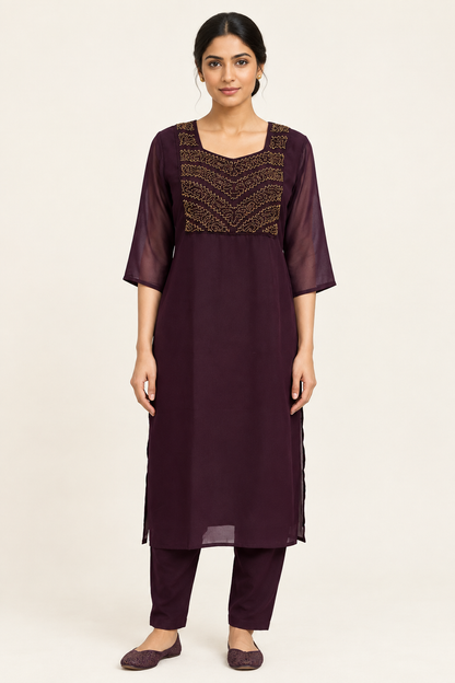 Indian model in dark plum kurta set with gold-toned handworked yoke, matching straight pants and sheer sleeves